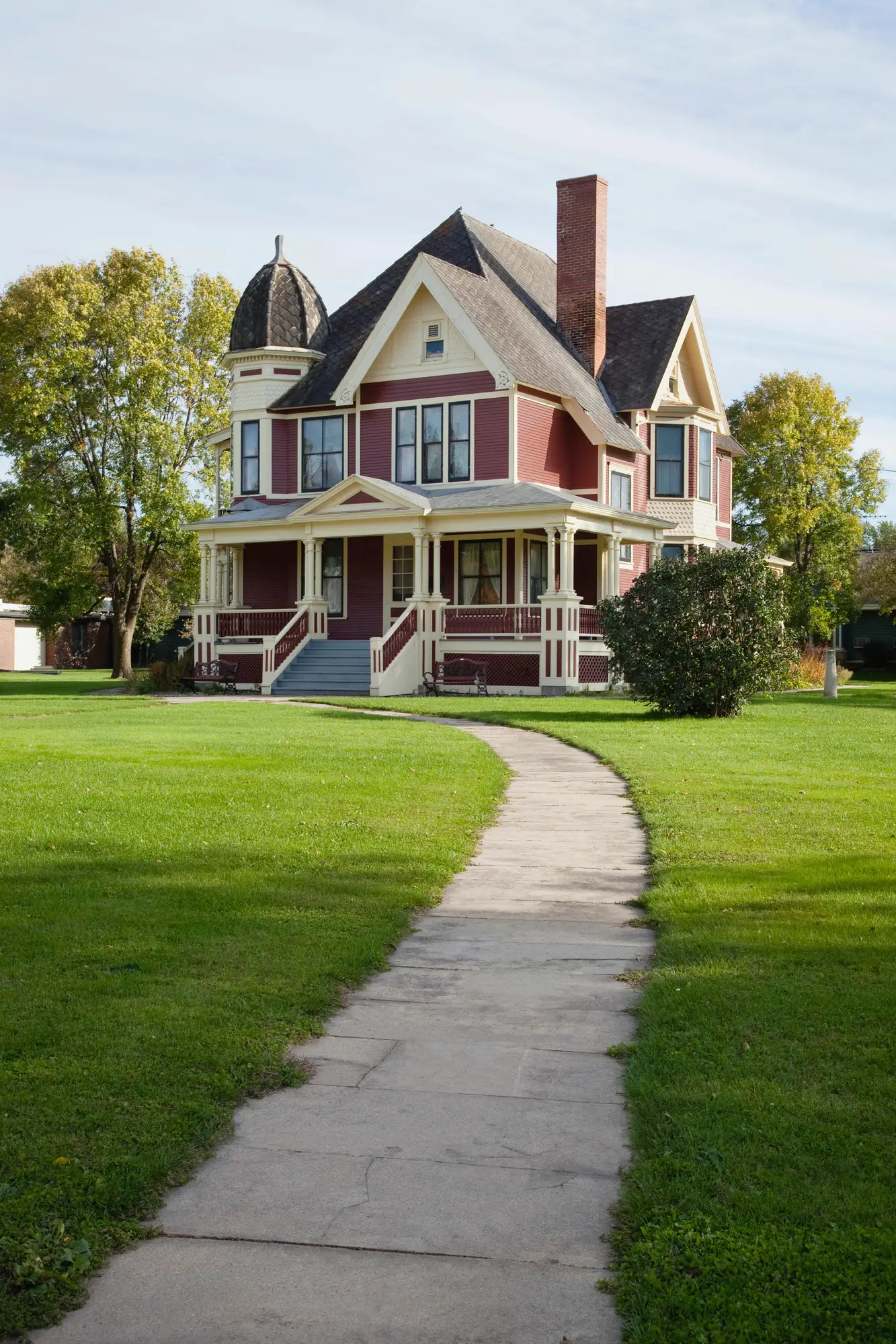 victorian house with lawn and sidewalk